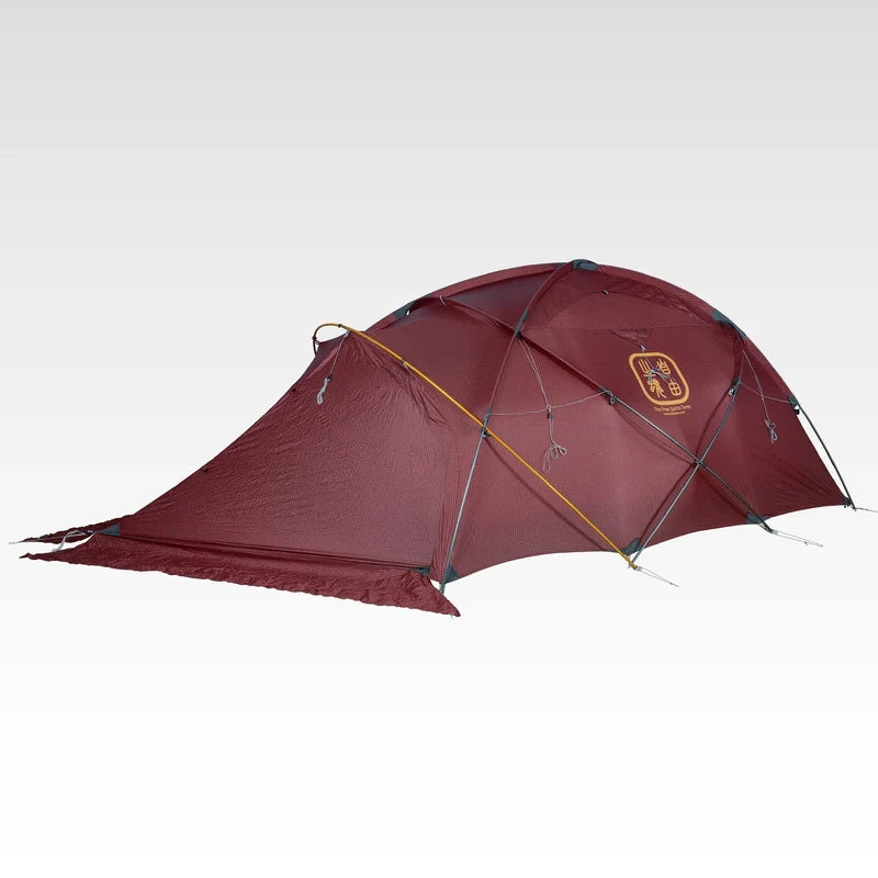 The Free Spirits Whisperwind S red dome tent, three-quarter view pitched with closed flysheet, studio background.