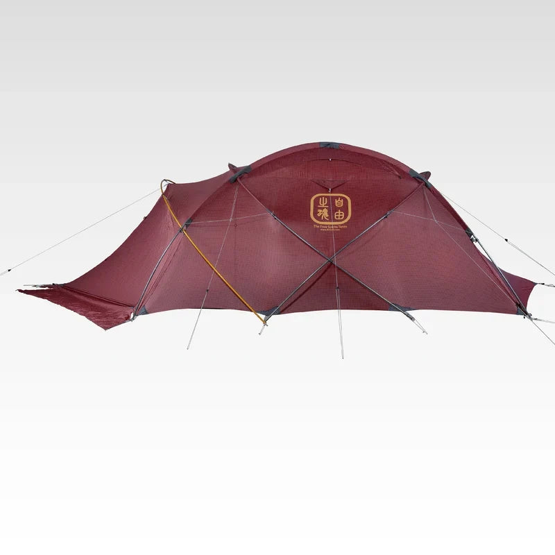 The Free Spirits Whisperwind S red flysheet front view, centered logo and crossing orange poles, studio background.