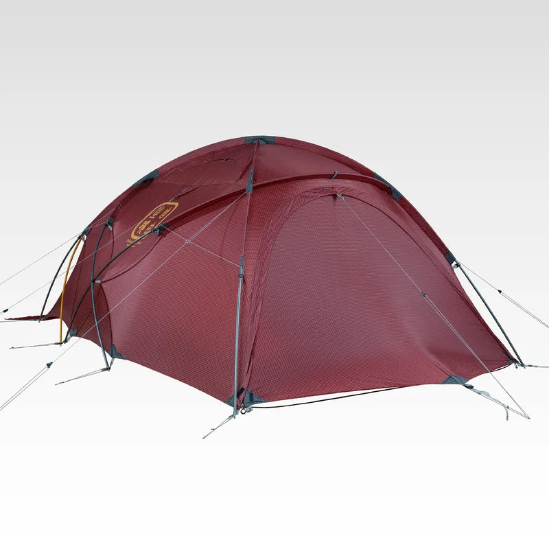 The Free Spirits Whisperwind S red dome tent low angle, crossed DAC poles and side guylines with logo on the flysheet.