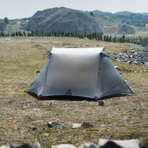 The Free Spirits Vista Tent in Rock Gray pitched on a high alpine meadow, front view of the closed flysheet.