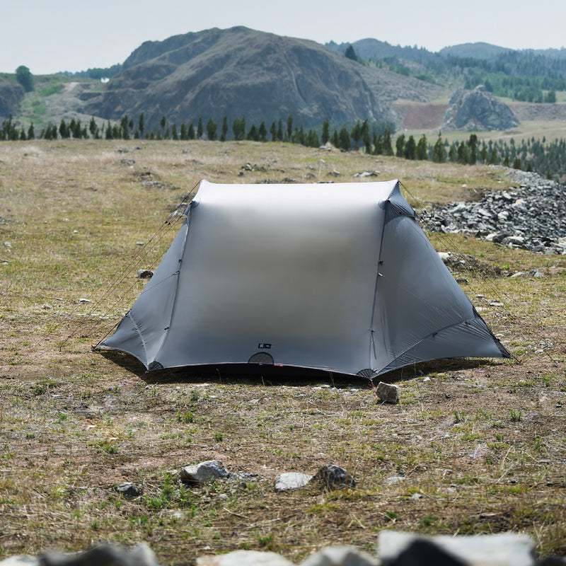 The Free Spirits Vista Tent in Rock Gray pitched on a high alpine meadow, front view of the closed flysheet.